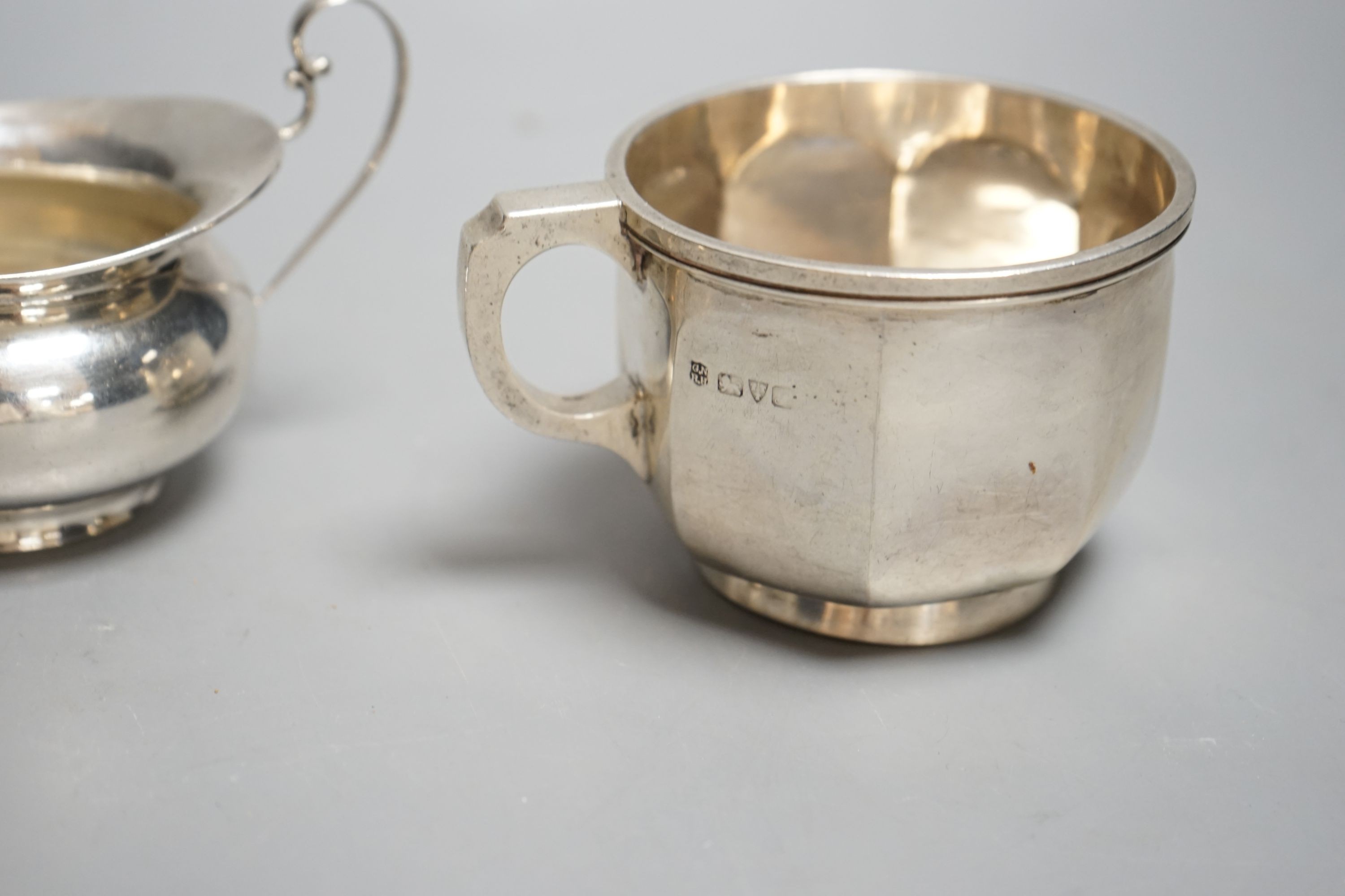 A Victorian silver christening mug, Birmingham, 1874, a later silver mug and a two handled sugar bowl